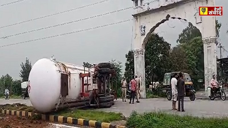 The gas tanker overturned in the middle of the road.