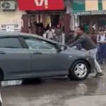 Lawyer trying to stop the car of the youth.